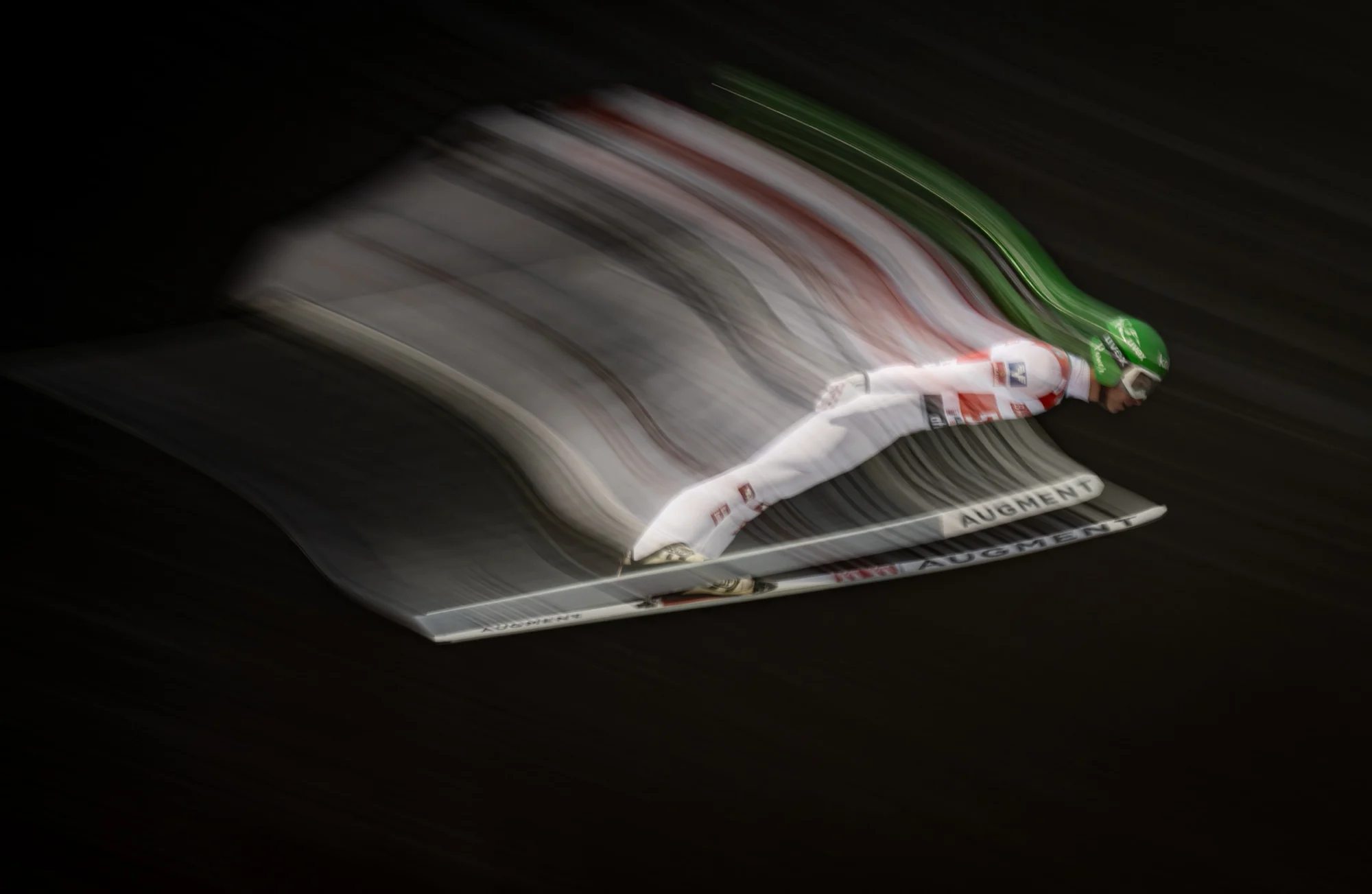 Ski jumper in flight, long-exposure motion blur