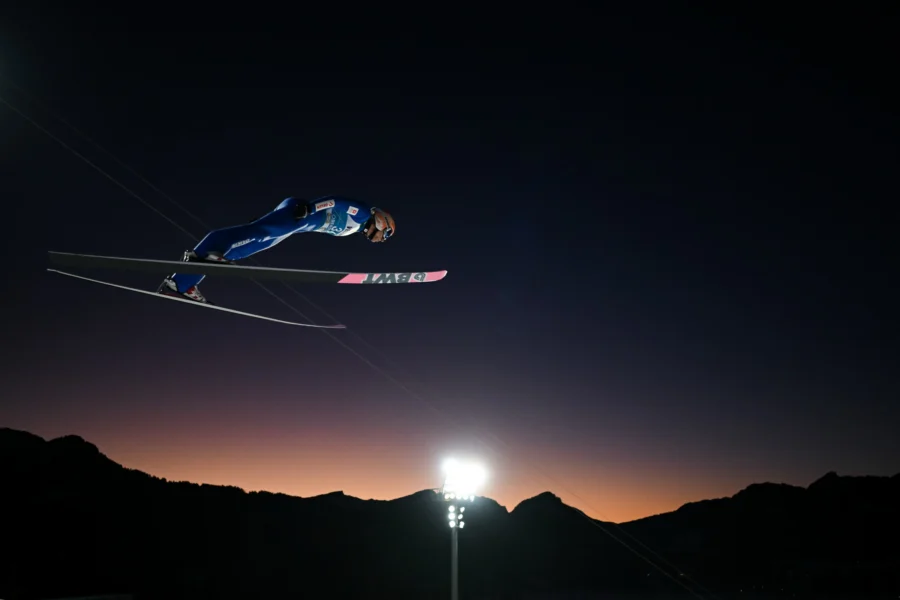 Ski jumper under floodlights at dusk, Four Hills Tournament Oberstdorf