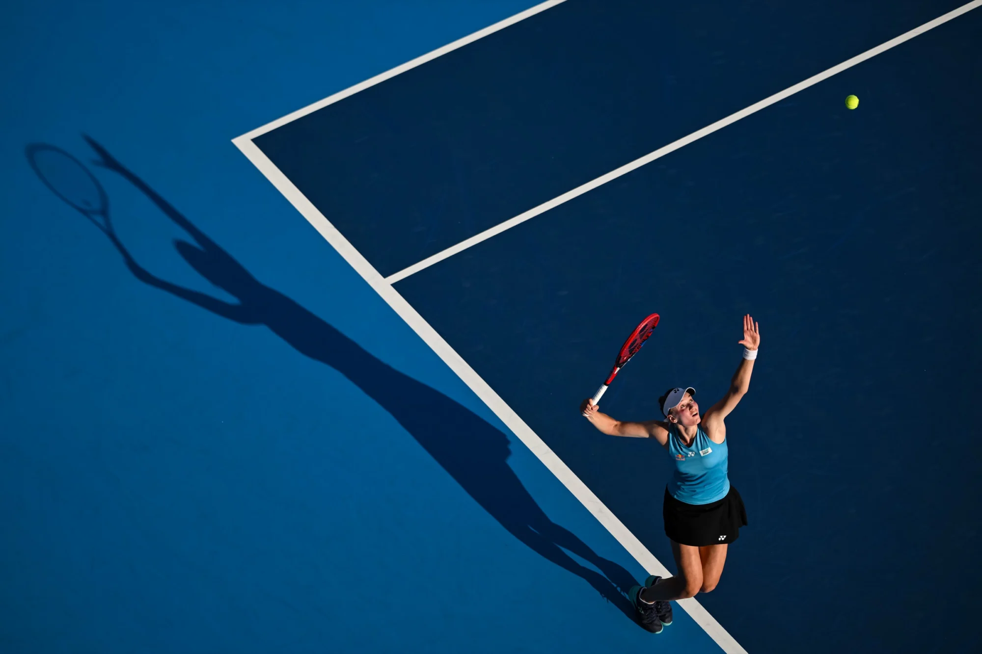 Tennis player serving on a blue hard court, seen from above, Cincinnati 2025
