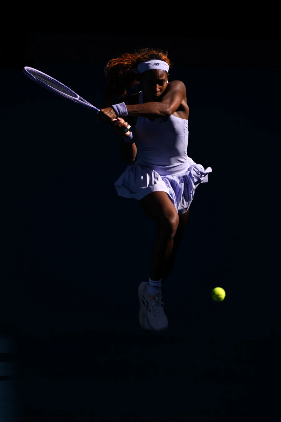Tennis player in silhouette against a dark background, Australian Open 2026
