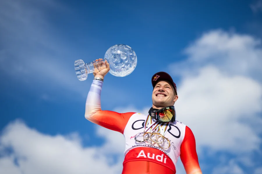 Marco Odermatt holding the crystal globe at the 2026 Alpine Ski World Cup Finals