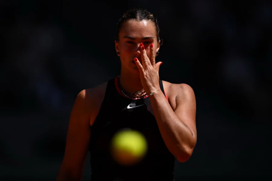 Tennis player in the shadows with the ball in the foreground, Roland Garros 2026