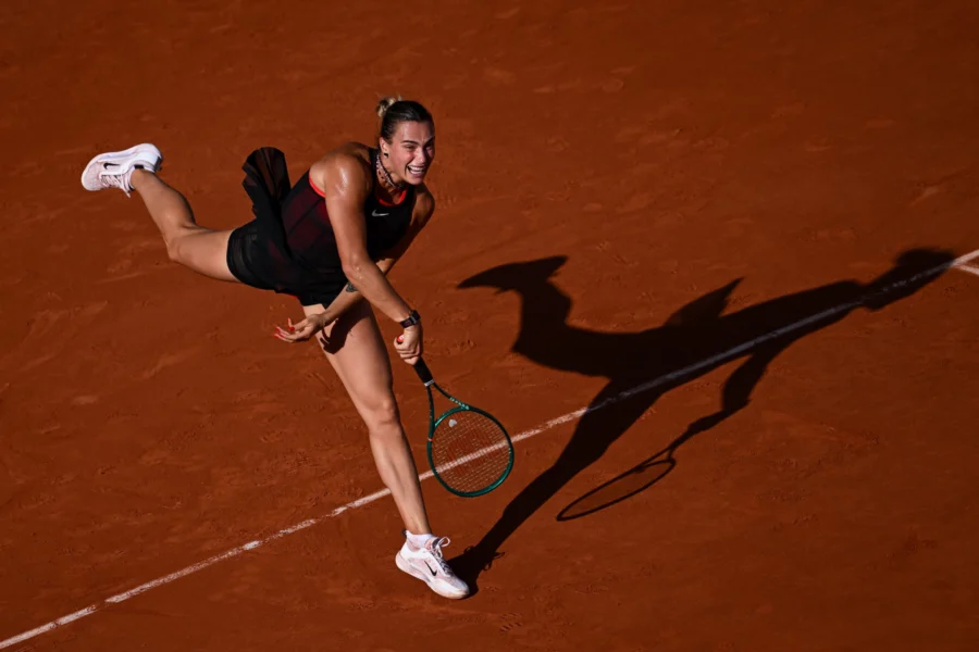 Tennis player stretching for a forehand on clay, Roland Garros 2026