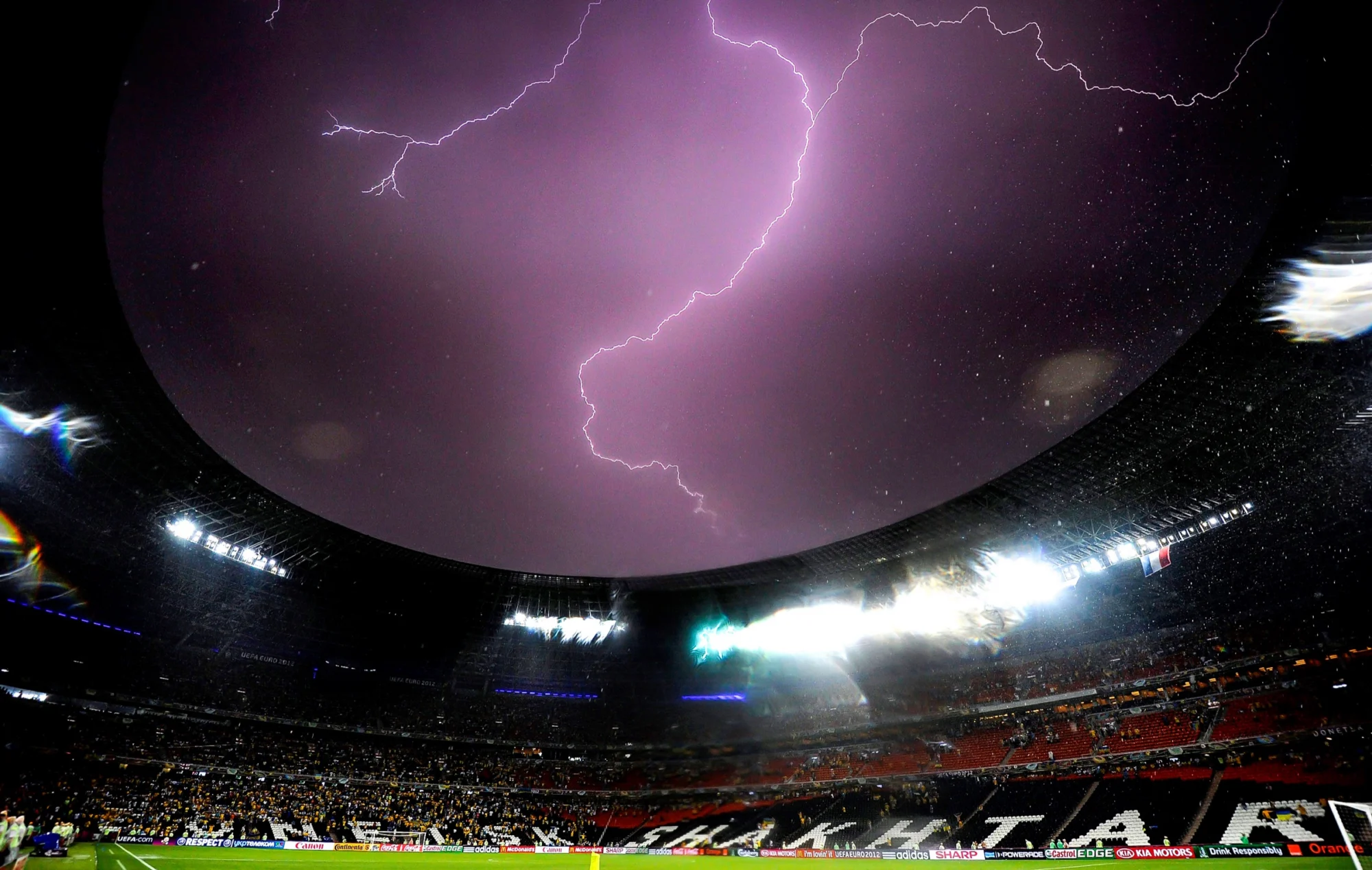 Lightning over a football stadium at night